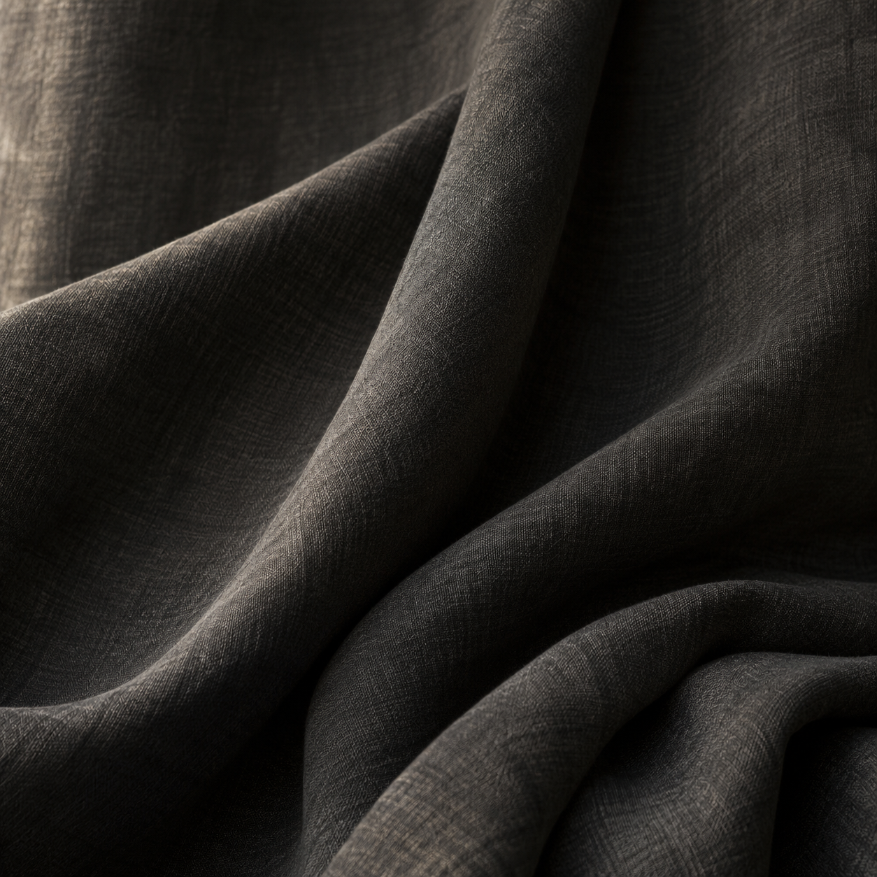 Soft folds of charcoal fabric, an editorial mood study
